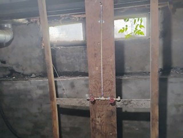 Two small basement windows set high in an old basement wall